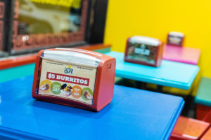 napkin holder with $5 burrito promotion Cactus Cafe graphic design example