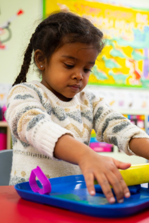 Little girl using Play-Doh