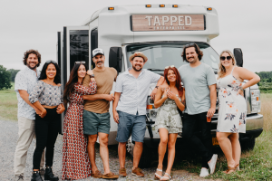 people standing outside the bus
